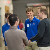 high school students laughing with a presenter